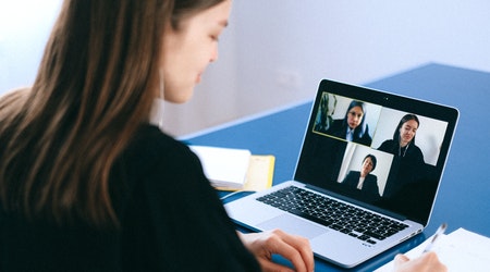 A woman conducts an online meeting