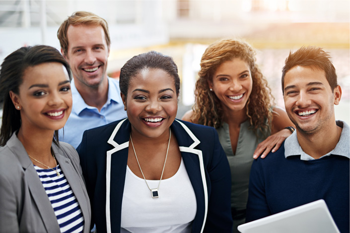 A diverse group of people smile together