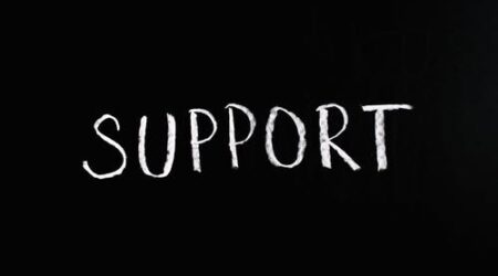 Support written in white chalk on a black background