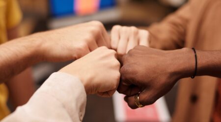 Multicultural hands fist bump in a circle