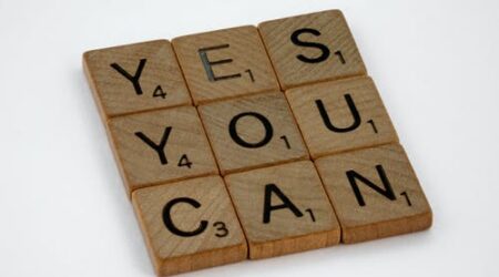 Scrabble letters spelling "Yes You Can"